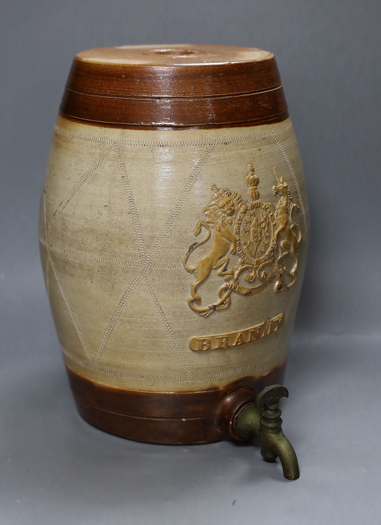 A 19th century salt glazed stoneware Brandy barrel, with Royal coat of arms sprigging, 33cm